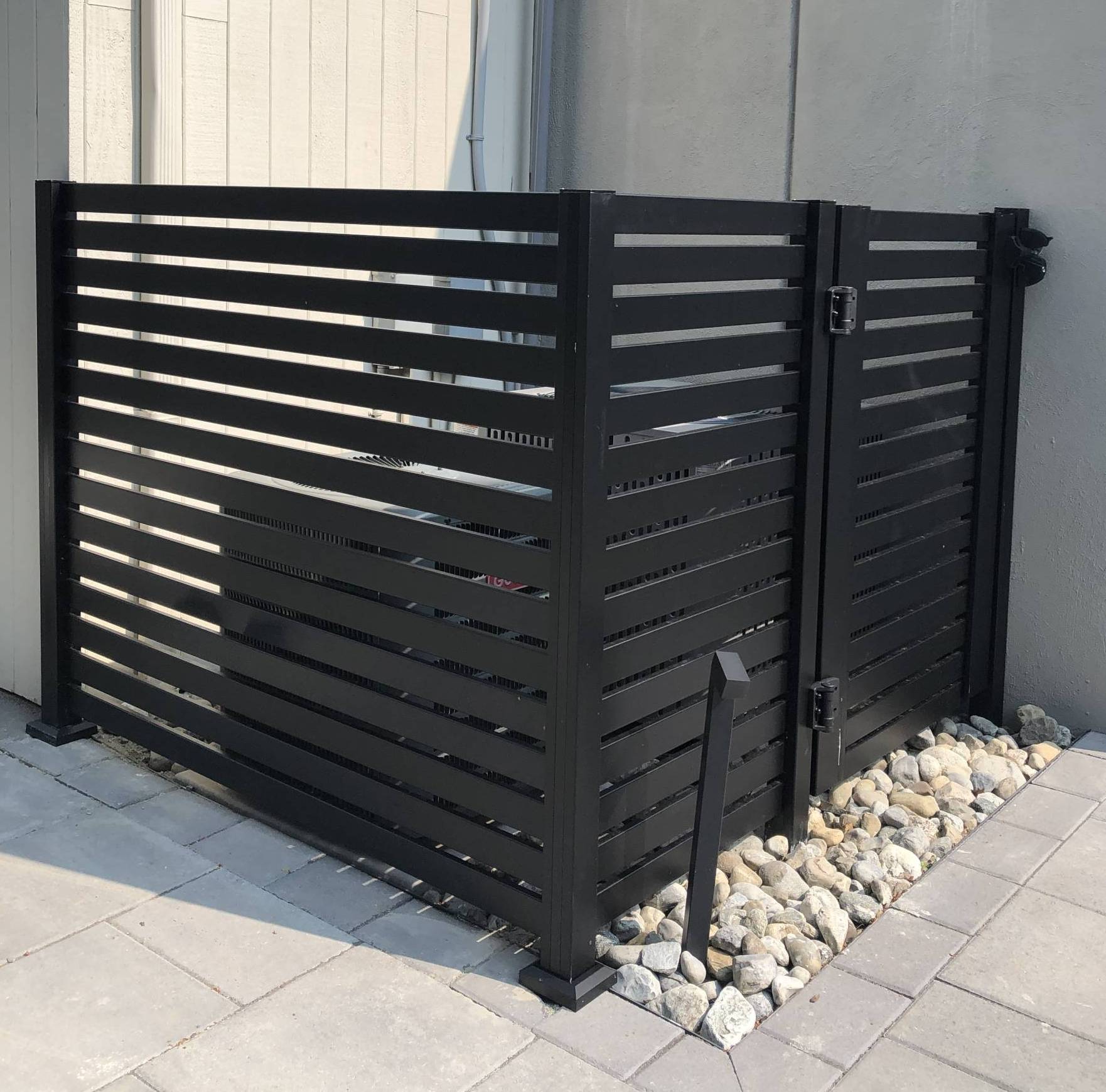 Installation of horizontal slat aluminum fence in textured black with walk gate